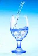 Glass with stem containing sparkling, clear vibrant and refreshed revitalized water.